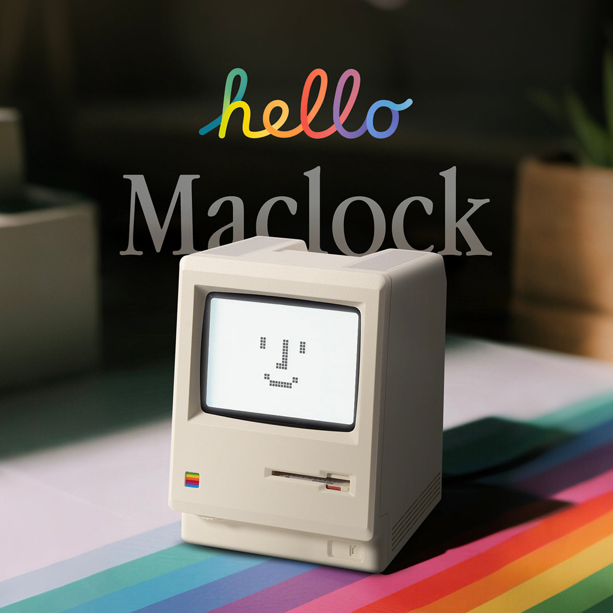 Maclock retro Macintosh clock displayed on a colorful Apple-inspired desk mat