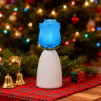 Blue blooming rose lamp by a Christmas tree